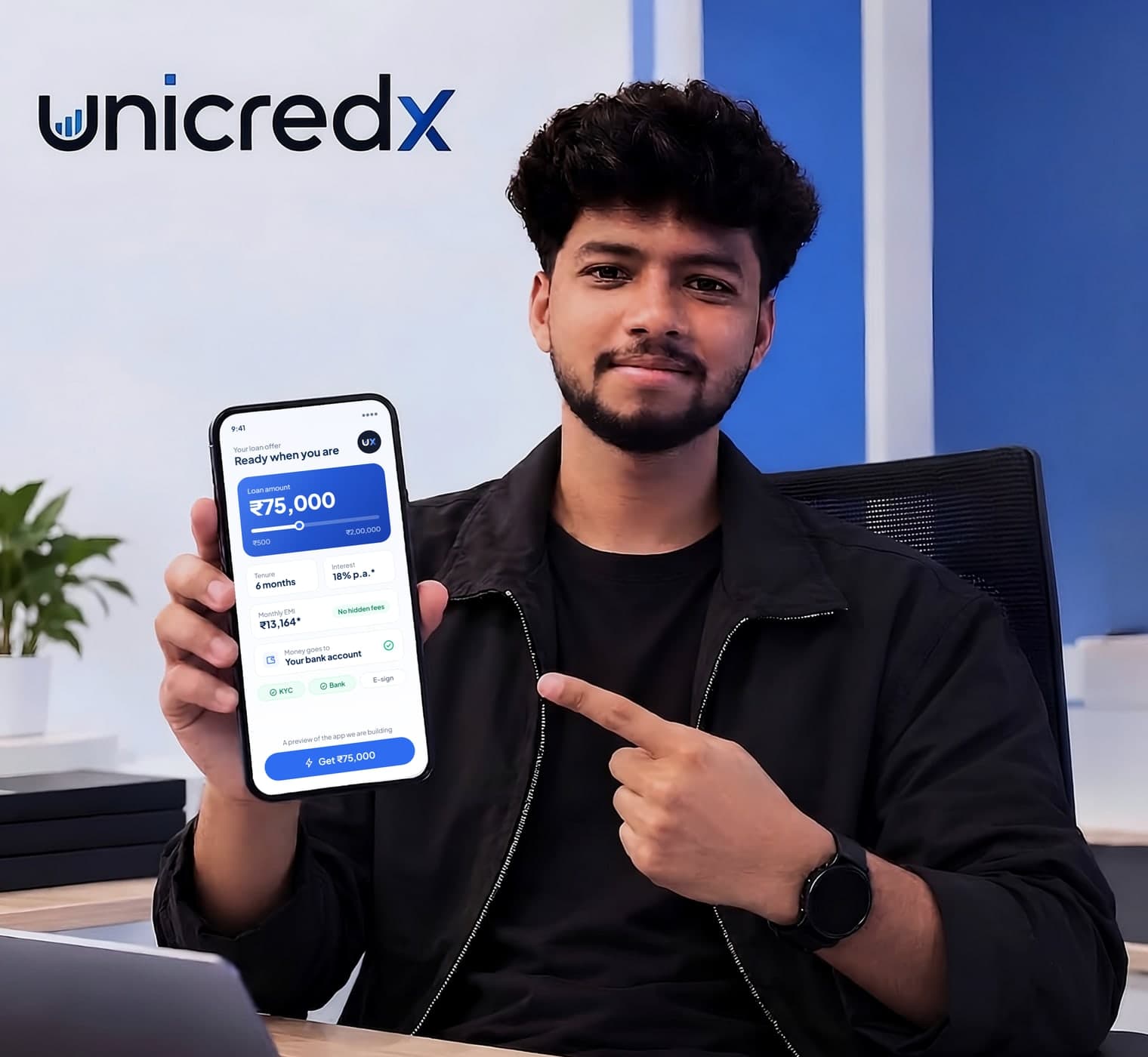 Ujwal Thakur holding a phone showing a preview of the UniCredX app with a sample ₹75,000 loan offer